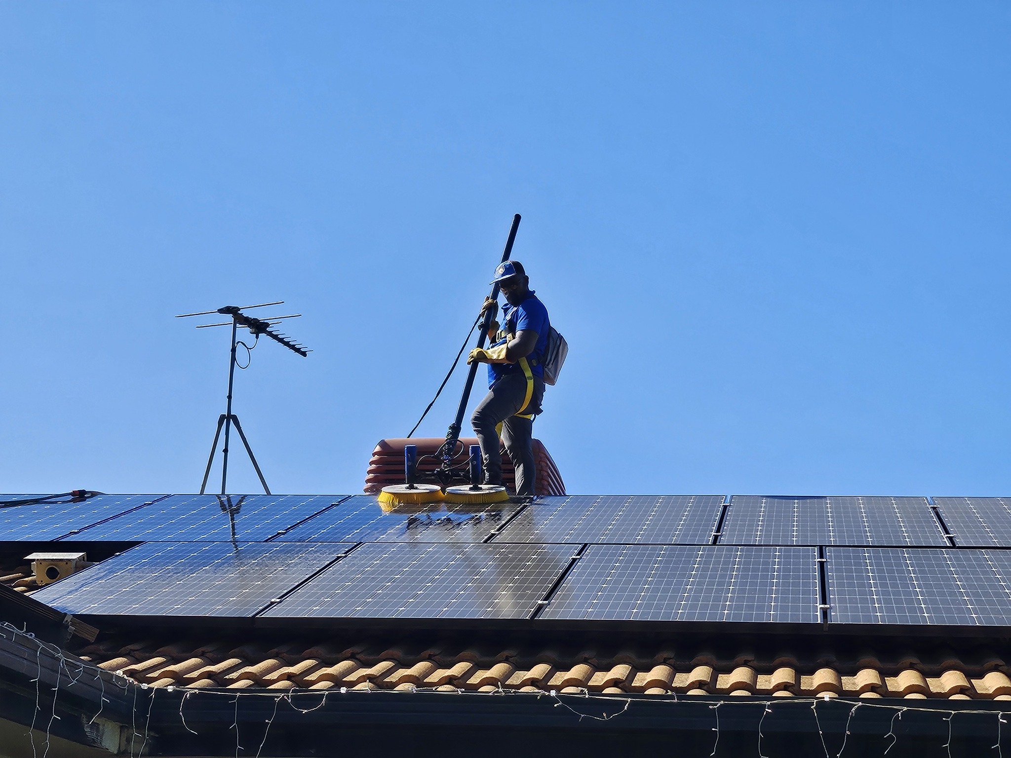 Here Comes The Sun Solar team cleaning solar panels